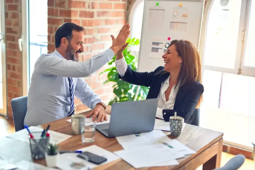 Two business people high fiving